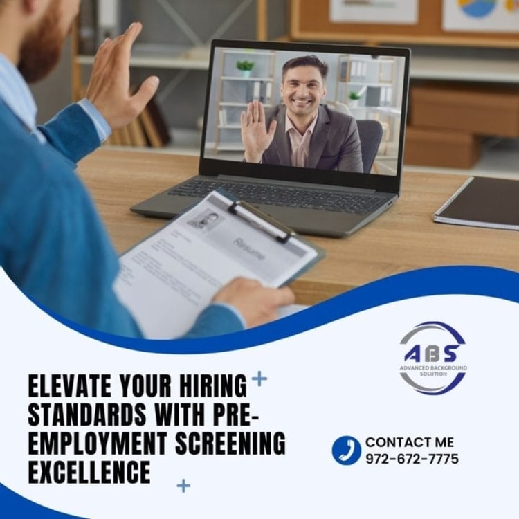 A man sitting at a desk in front of a laptop computer