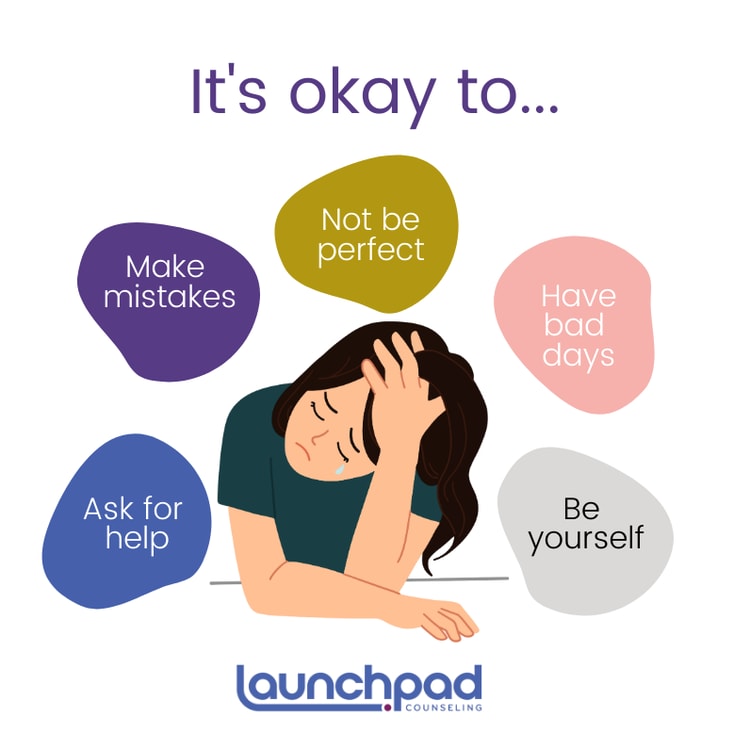 A woman sitting on the ground with her head in her hands