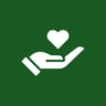 A hand holding a heart on a green background