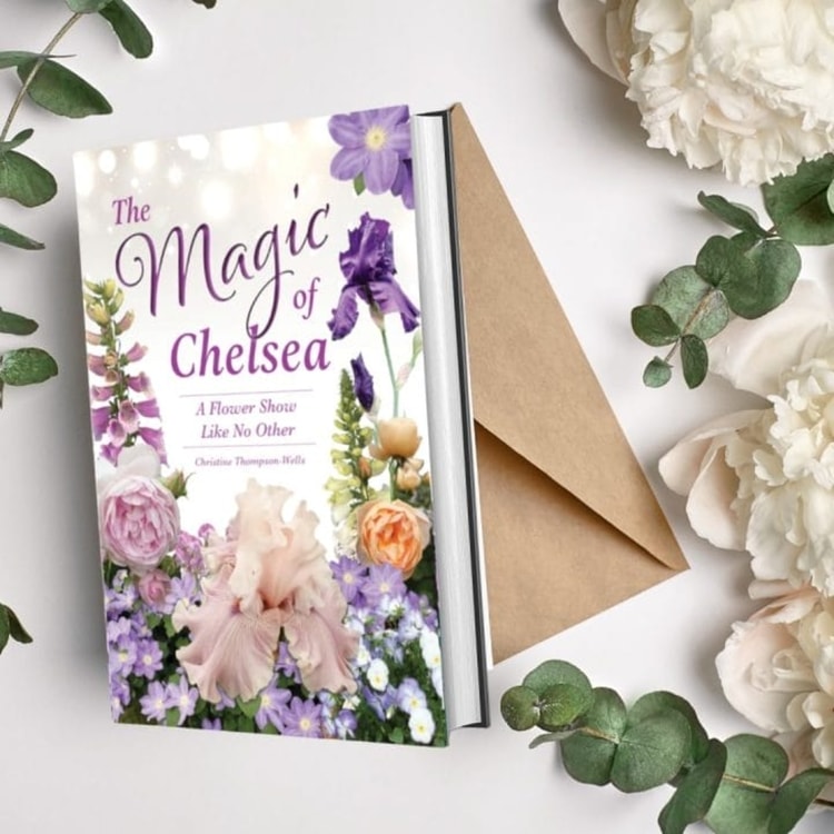 The magic of chelsea book next to a bouquet of flowers