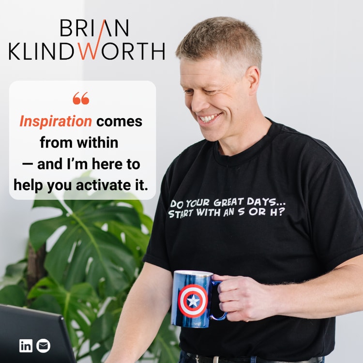 A man holding a coffee mug and a laptop