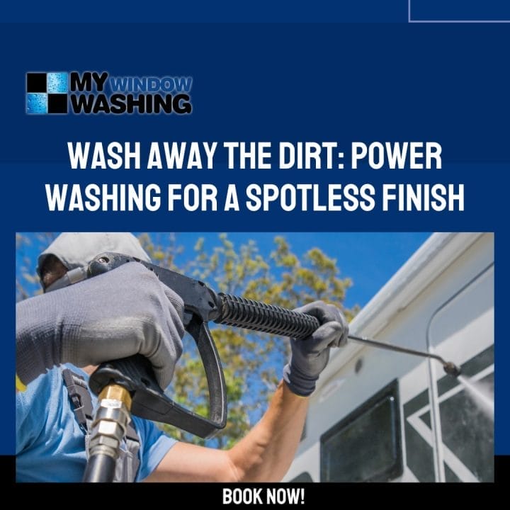 A man using a power washer to clean a window