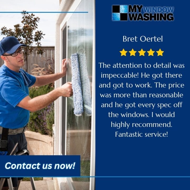 A man cleaning a window with a window washer