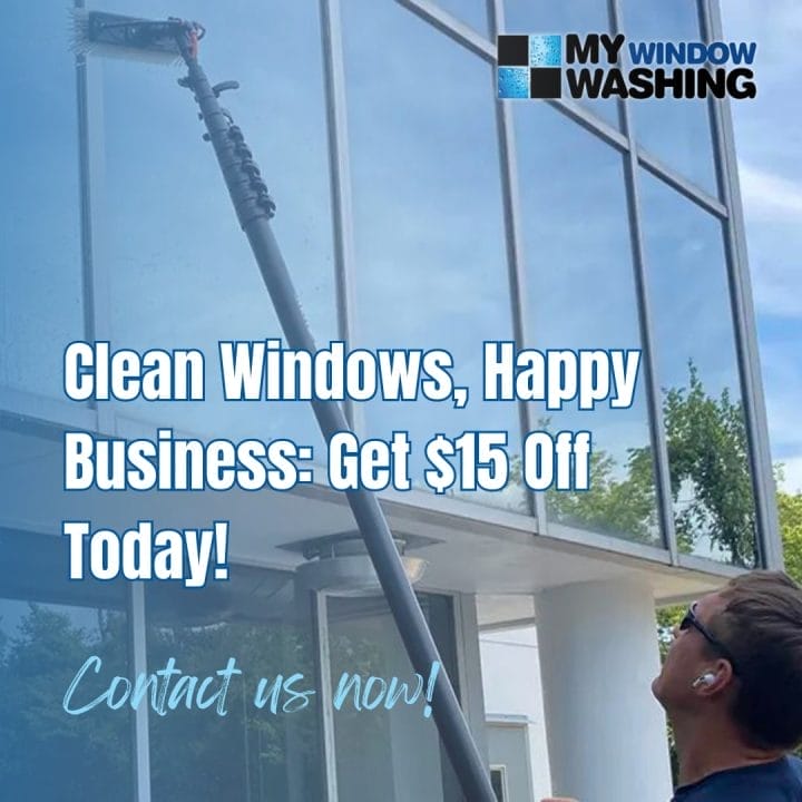 A man cleaning windows with a window washer