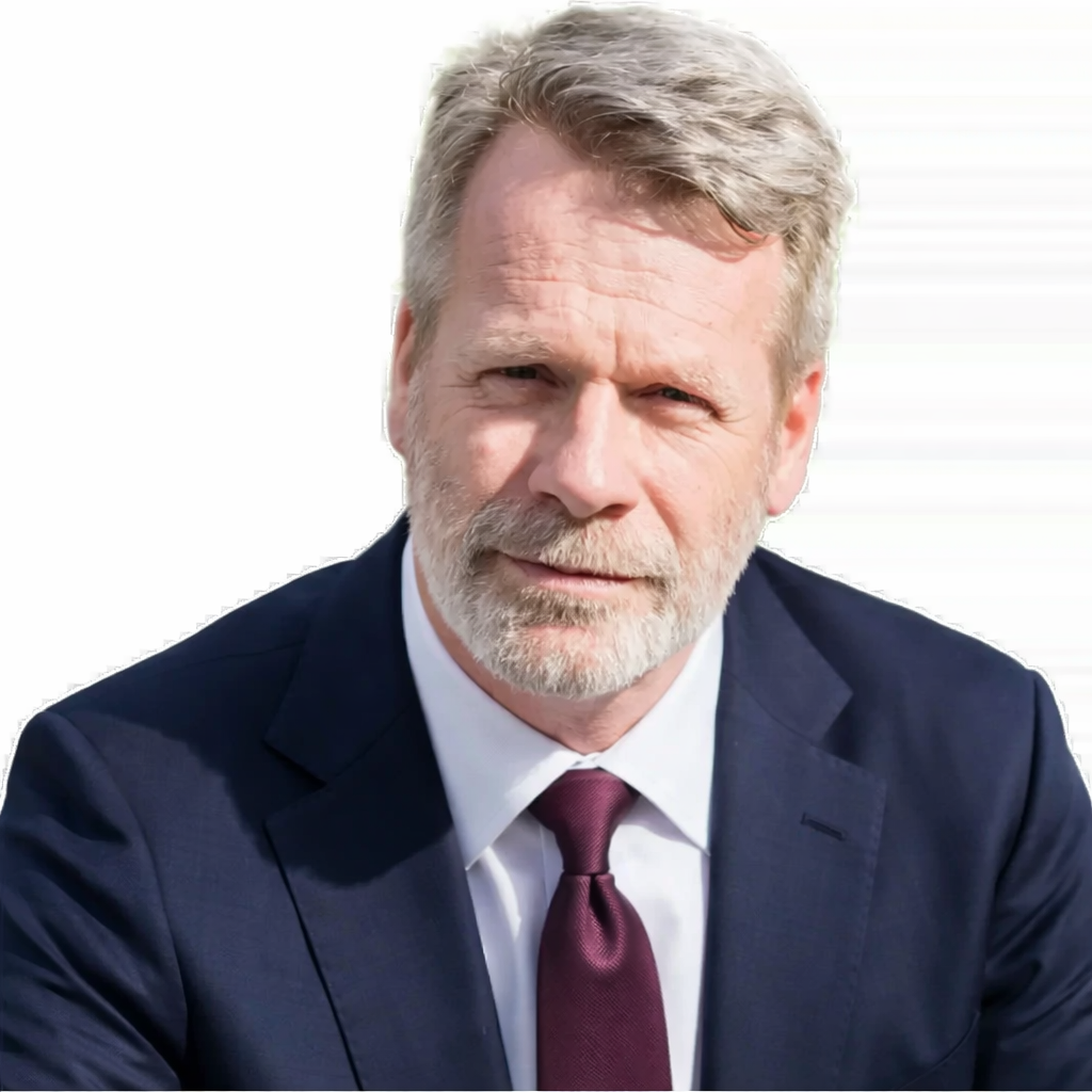 A man in a suit and tie looking at the camera