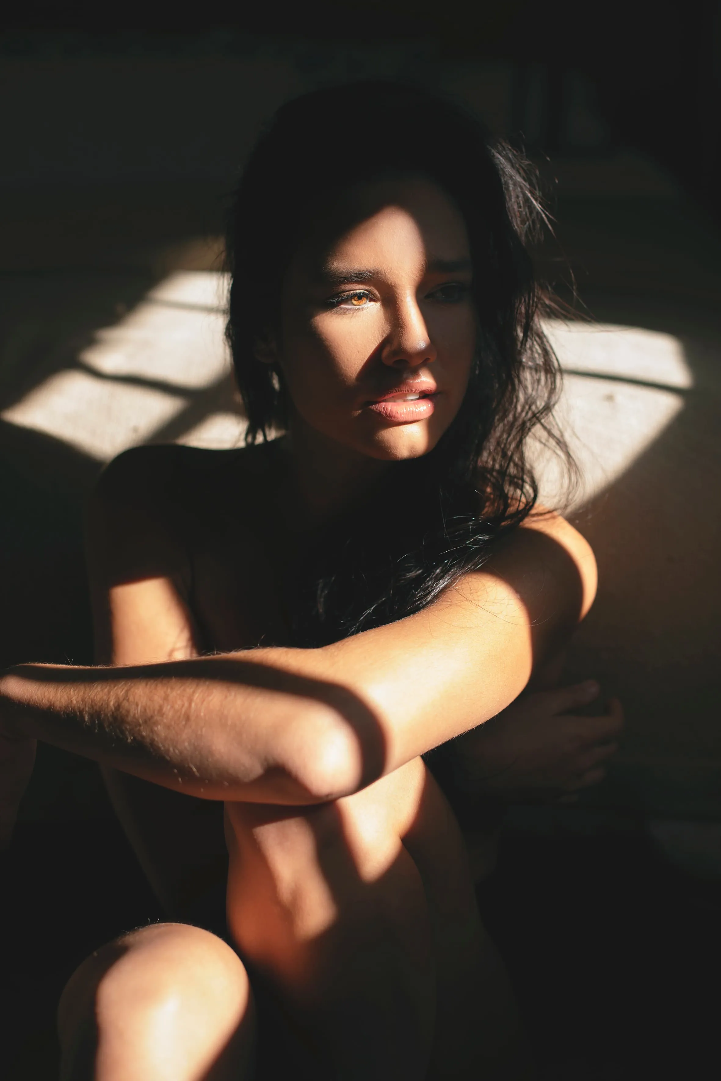 A woman sitting on the ground with her arms crossed