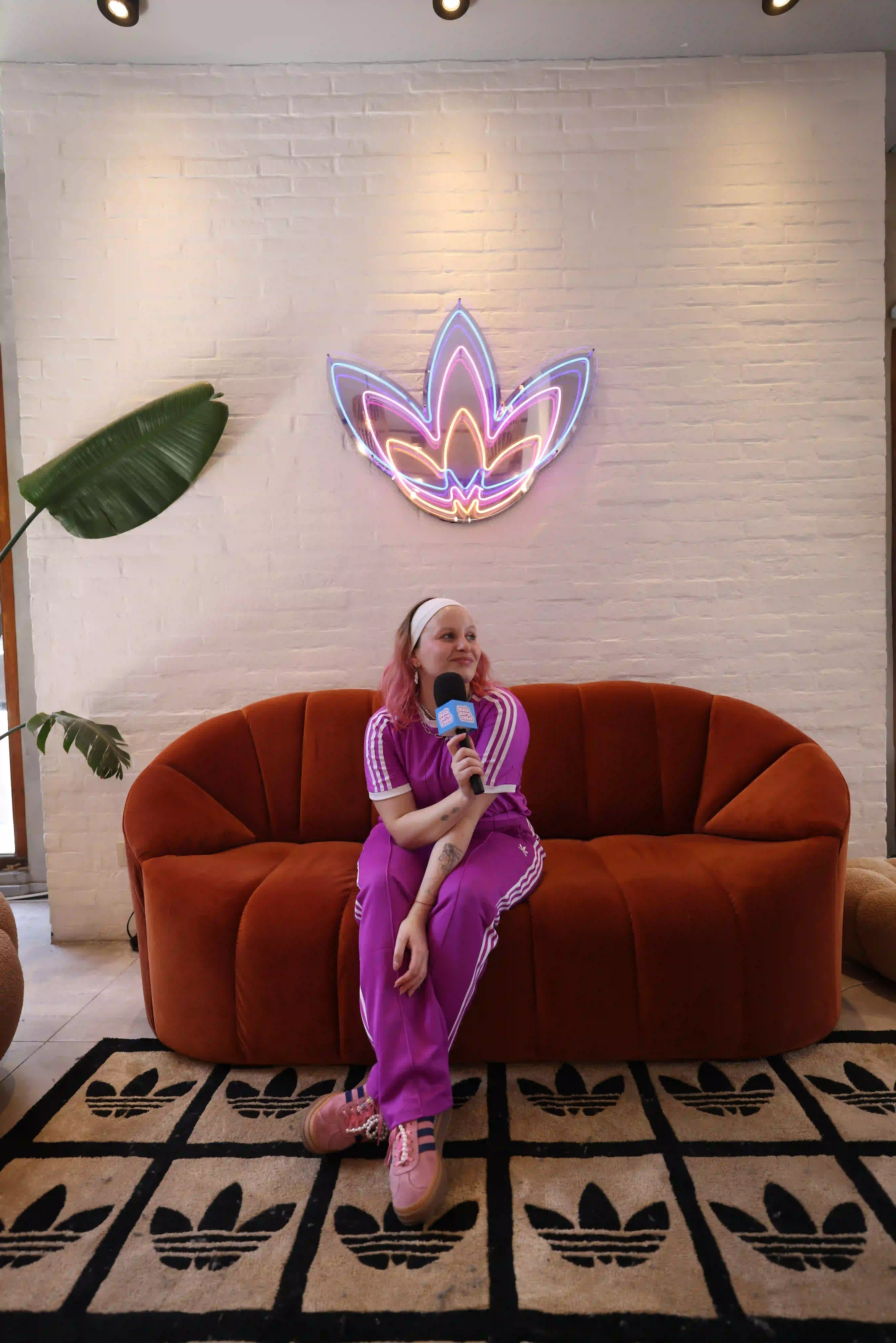 A woman sitting on a couch with a microphone