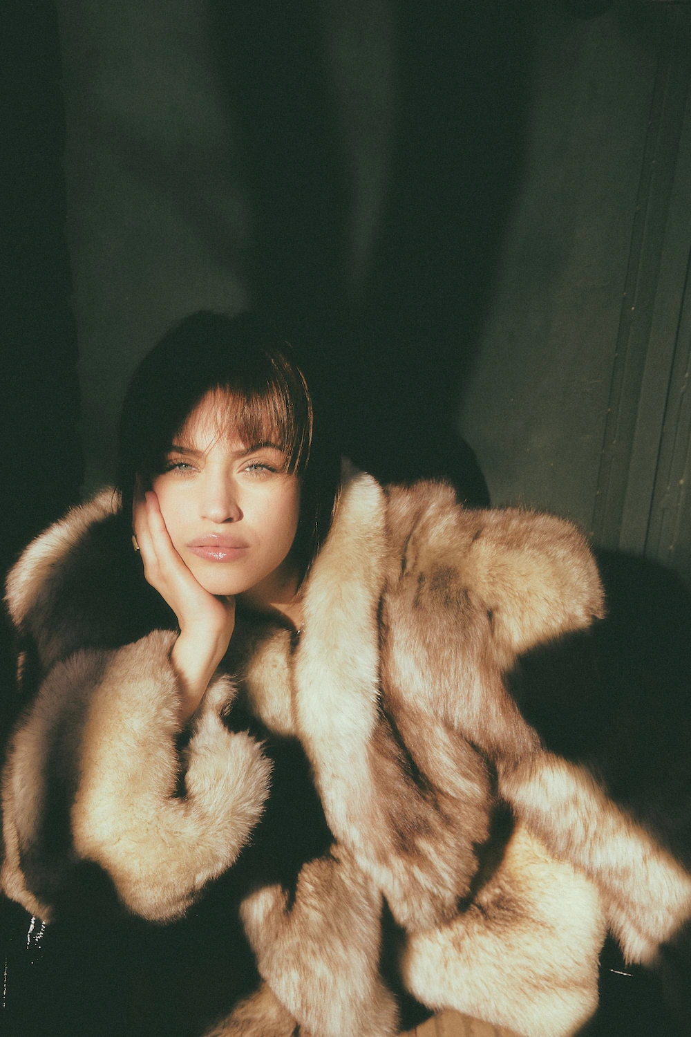 A woman in a fur coat posing for a picture