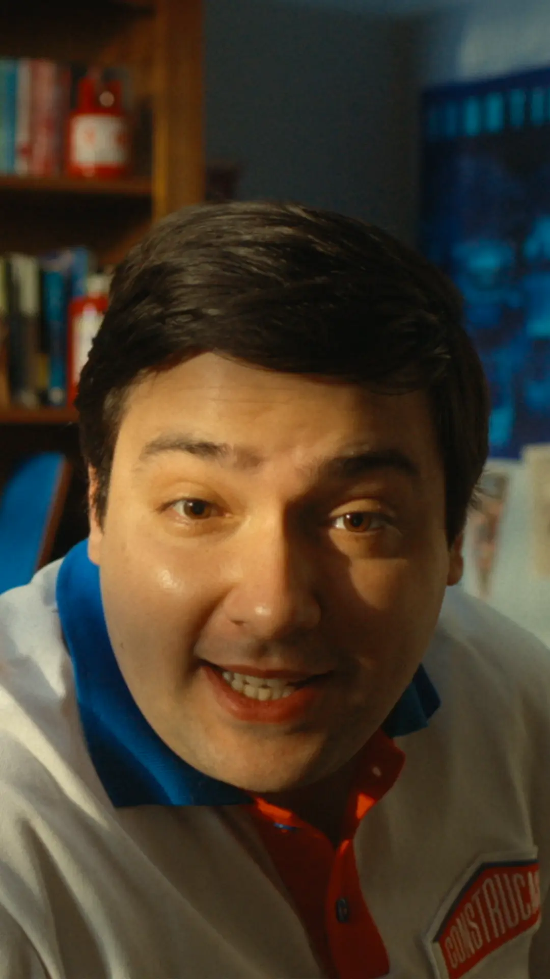 A man in a white shirt is smiling