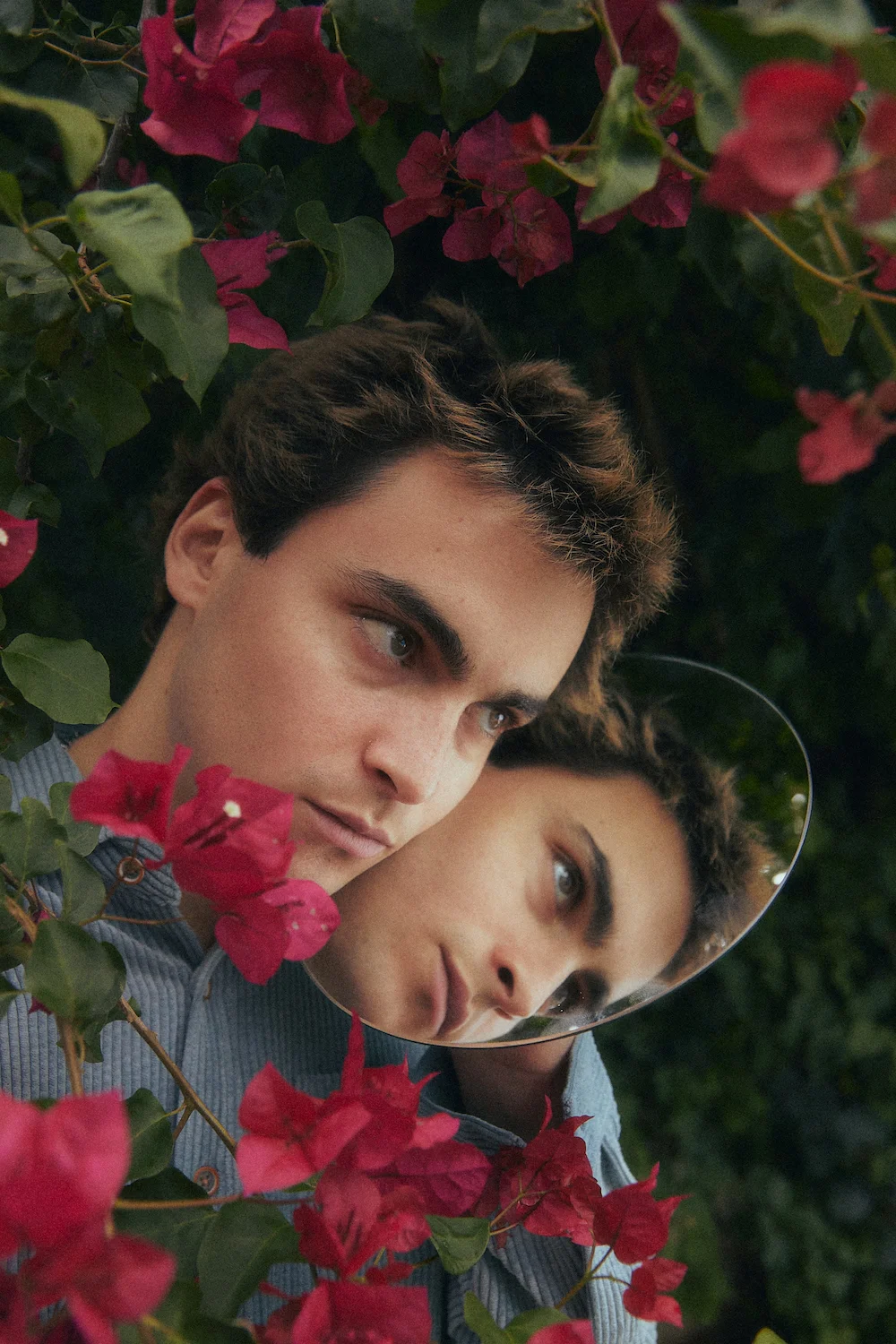 A man and a woman looking at each other through a mirror