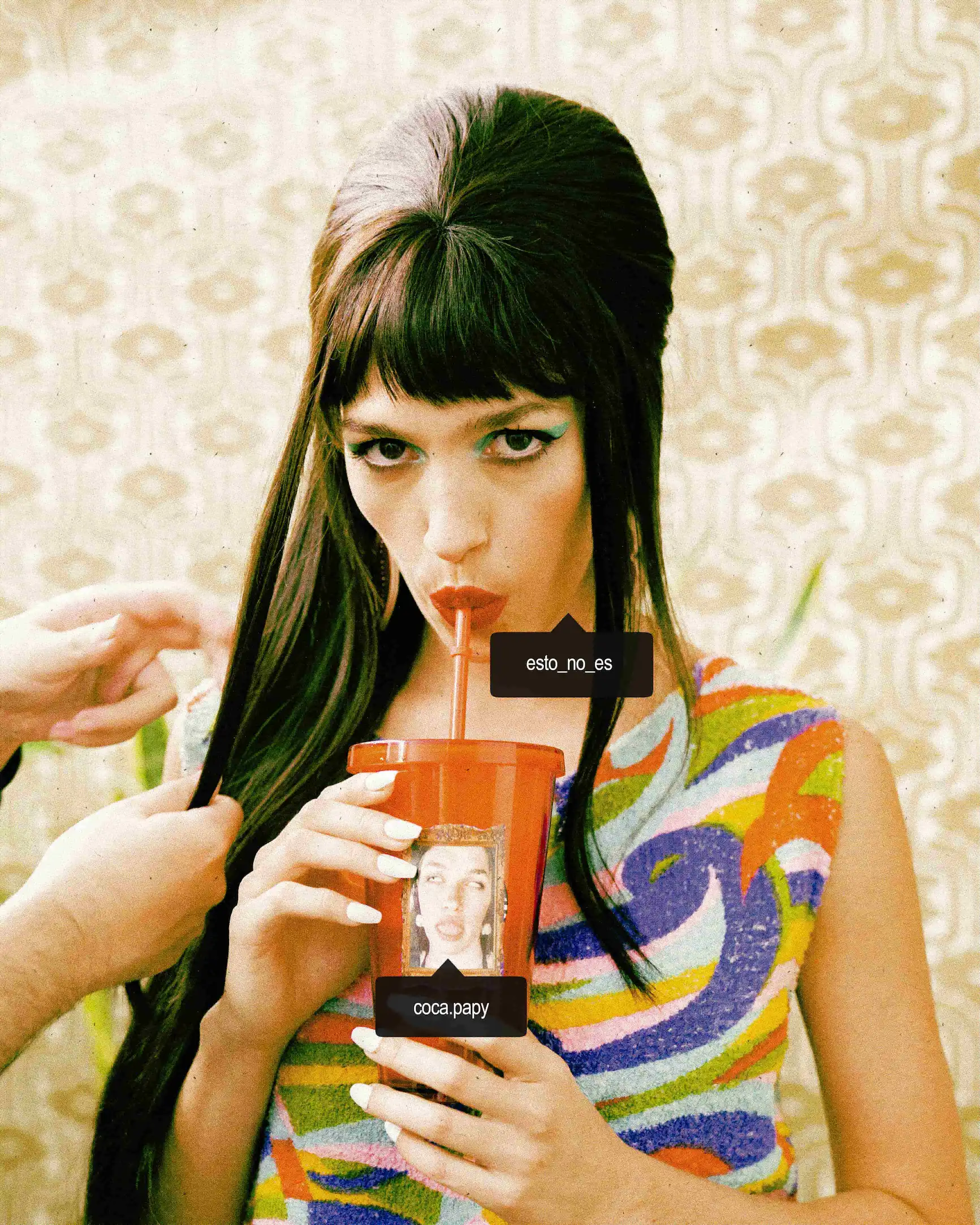A woman with long black hair holding a drink