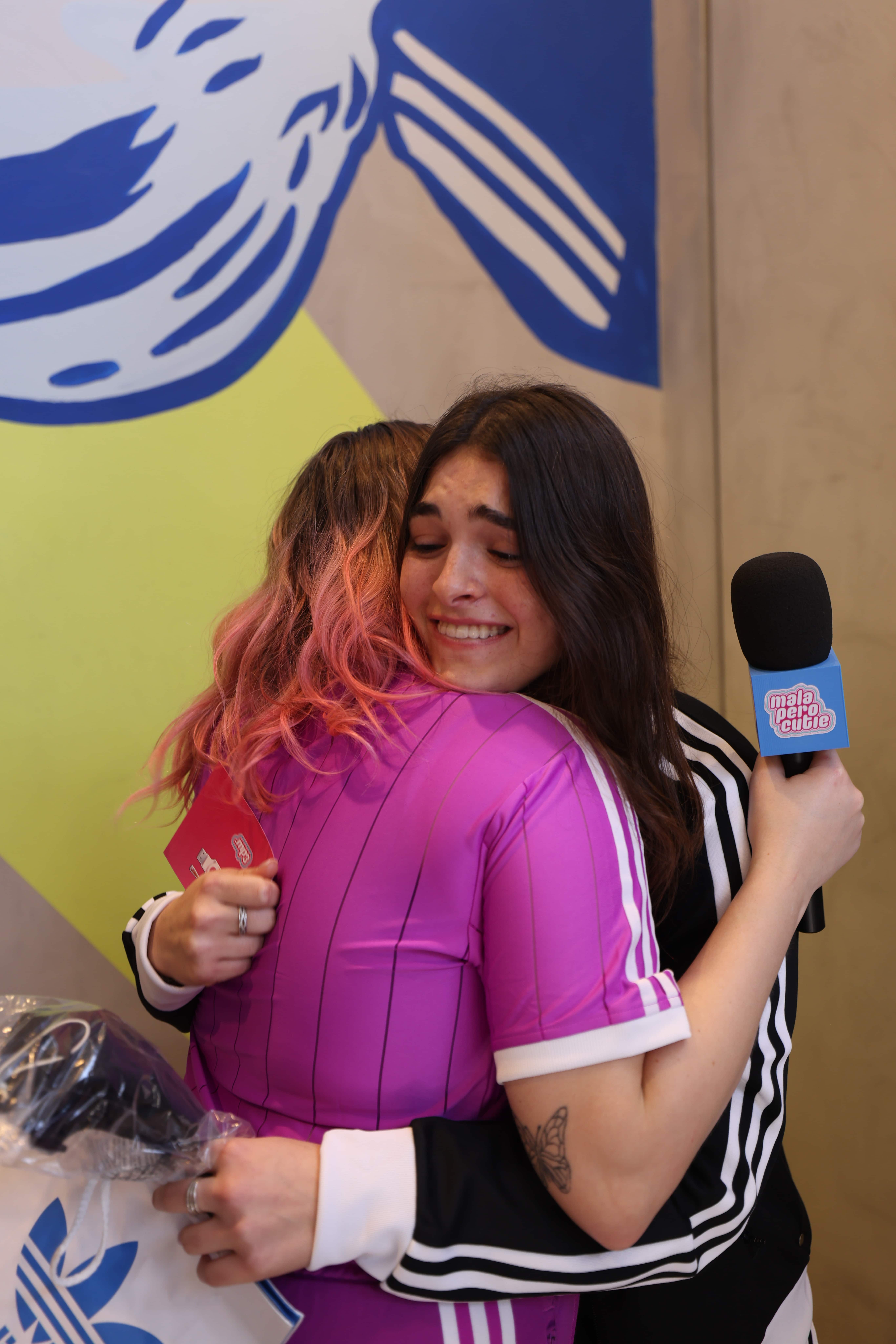 A woman holding a microphone and talking to someone