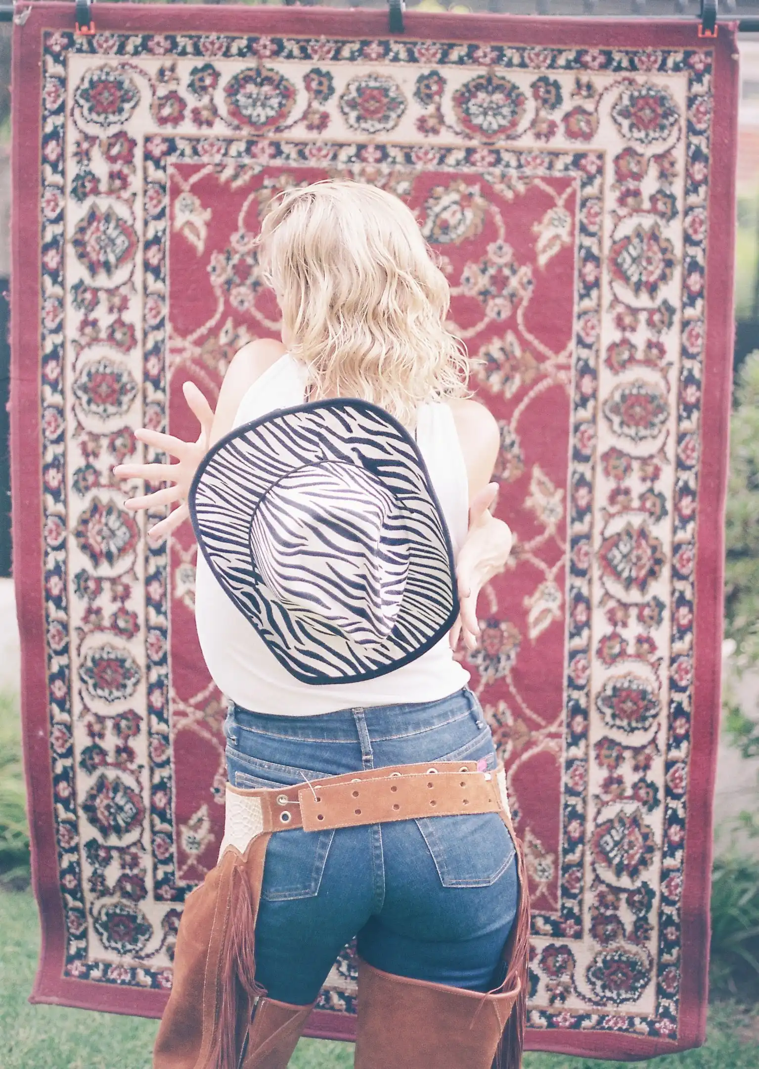 A woman is standing in front of a rug
