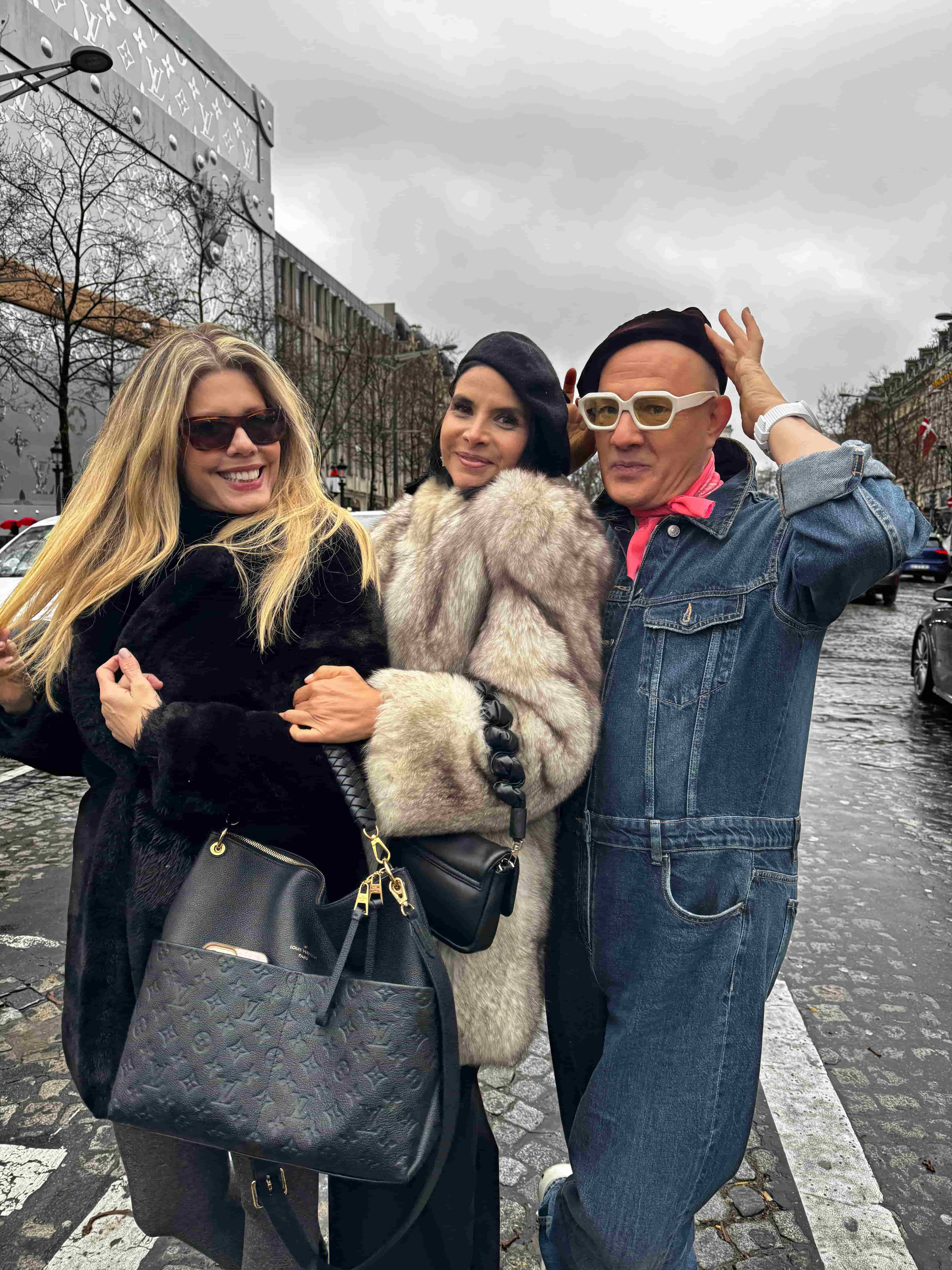 Two women and a man posing for a picture