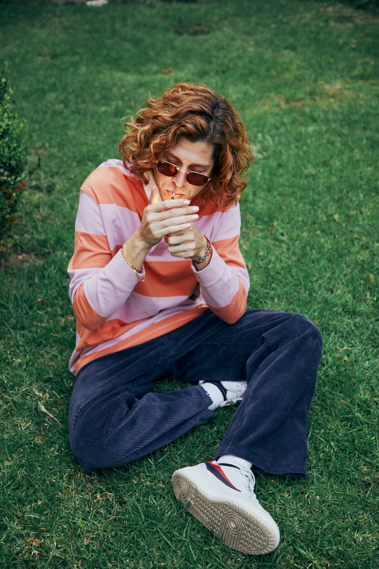 A woman sitting on the grass eating something