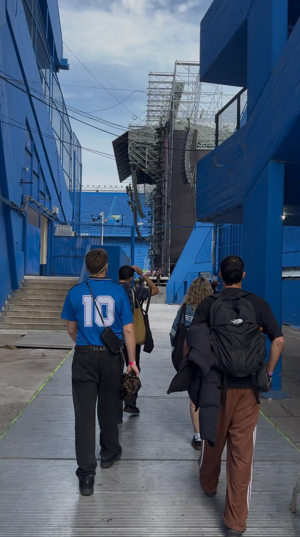 A group of people walking down a sidewalk