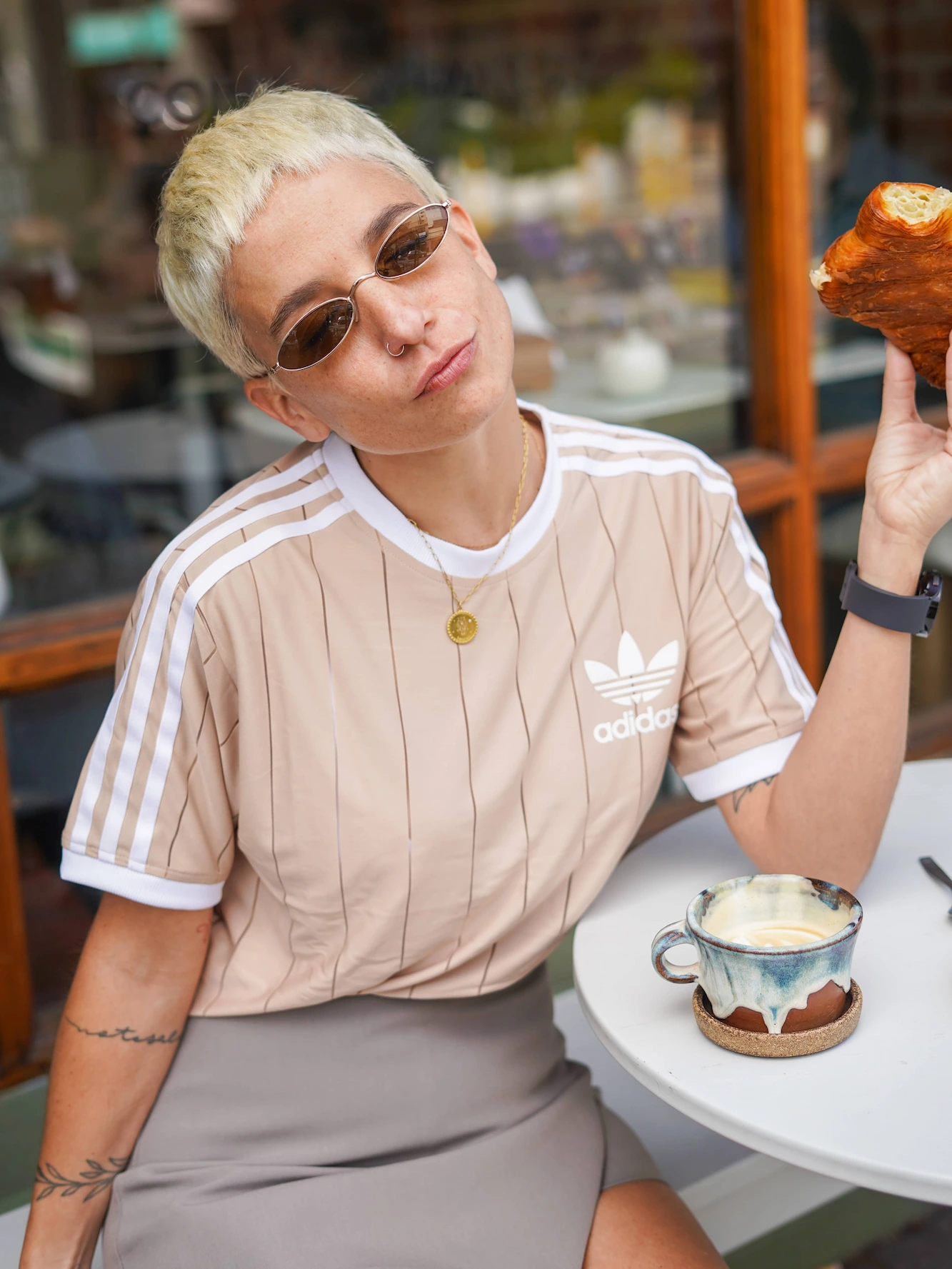 A woman sitting at a table holding a piece of food