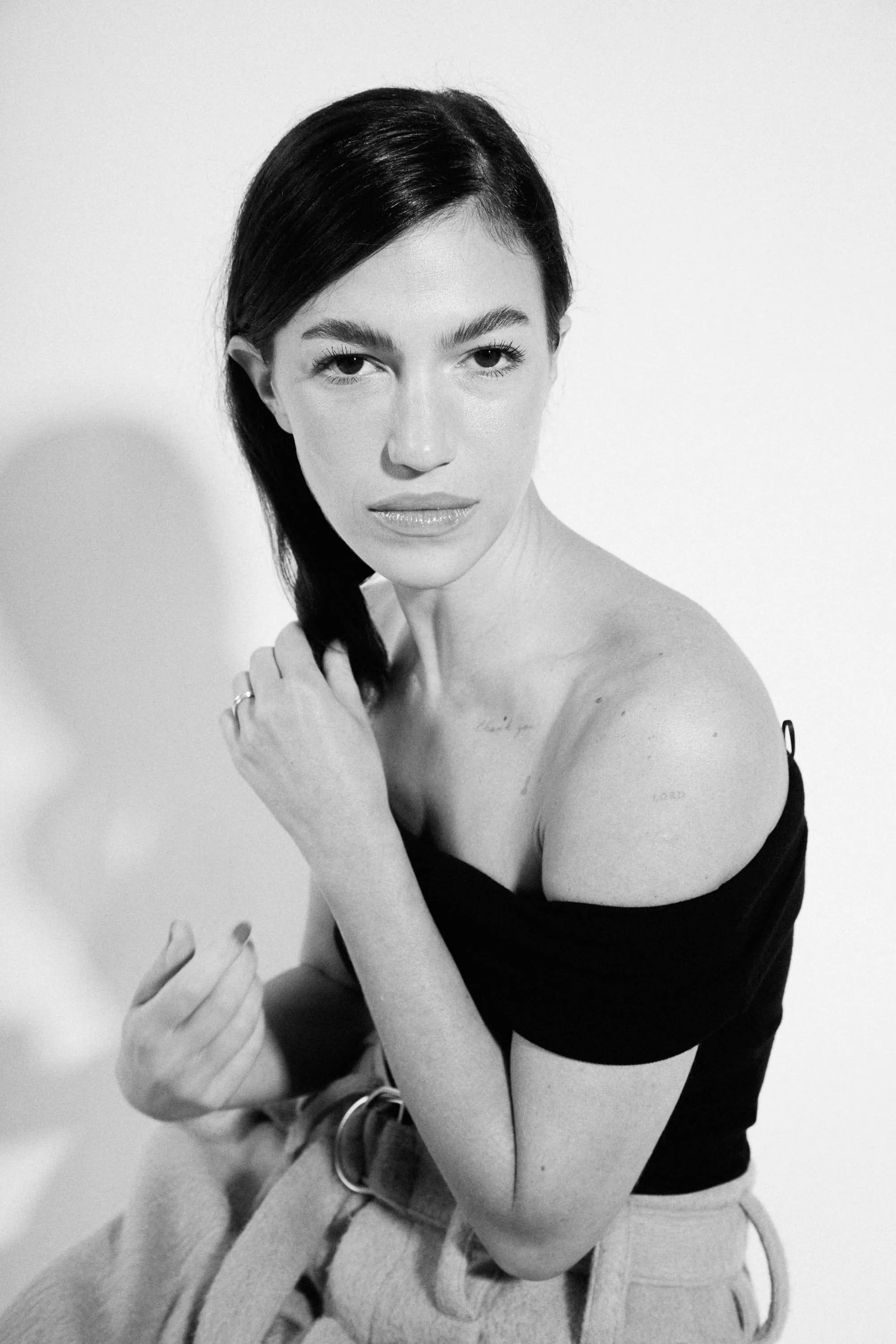 A black and white photo of a woman holding a cell phone