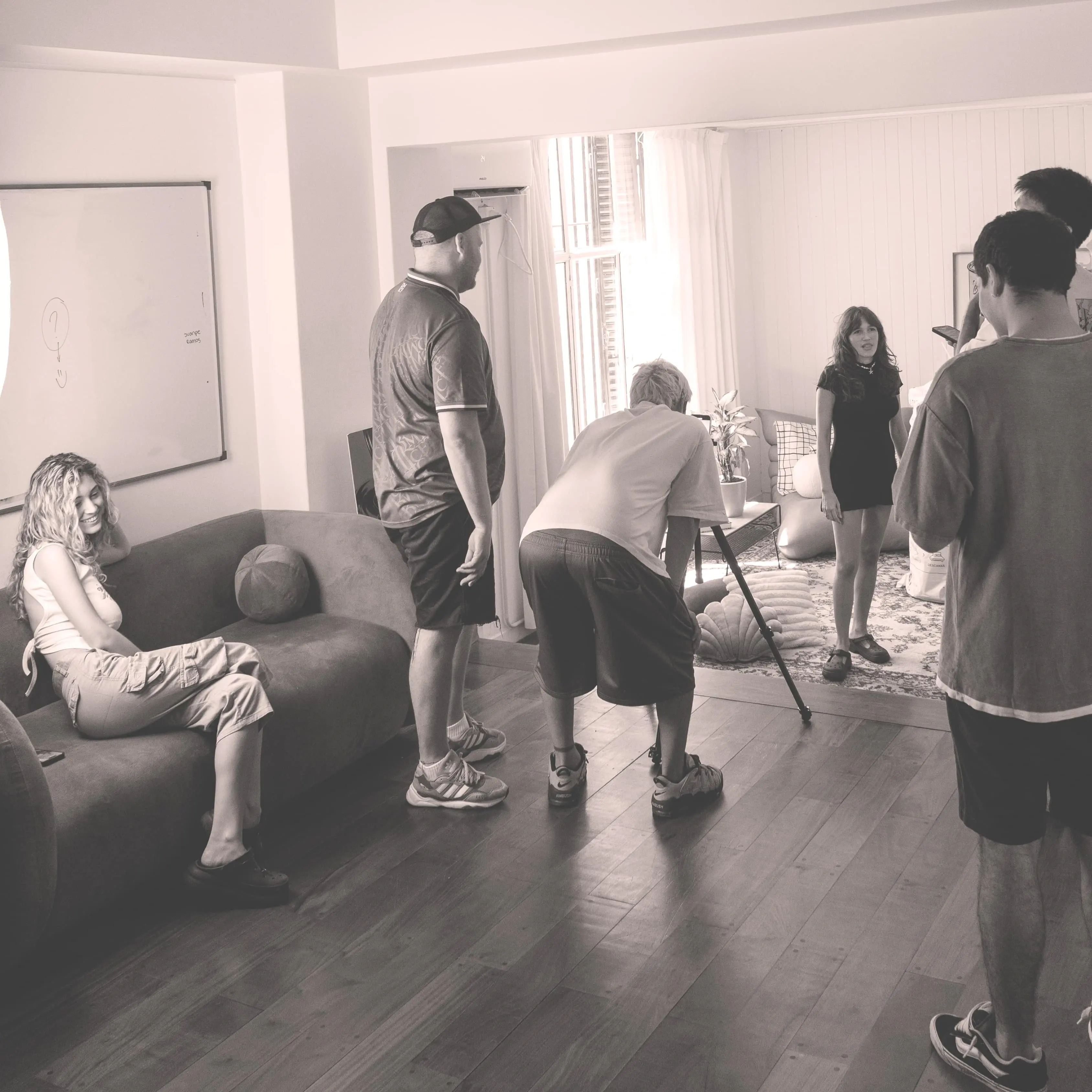 A group of people standing and sitting in a room
