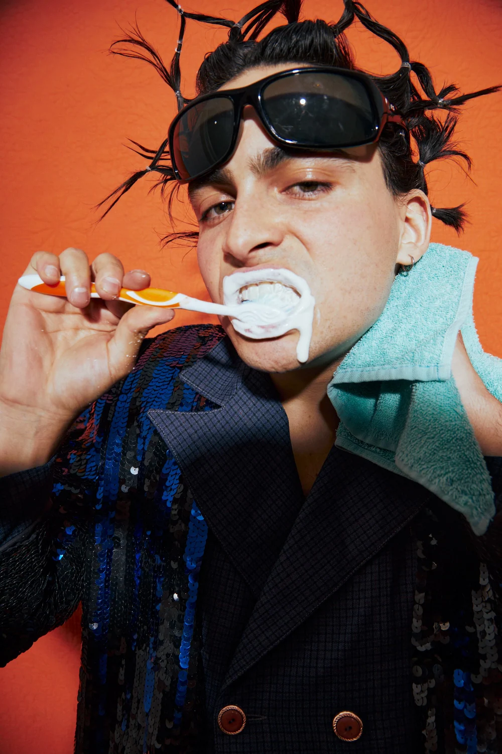 A young man brushing his teeth with an electric toothbrush