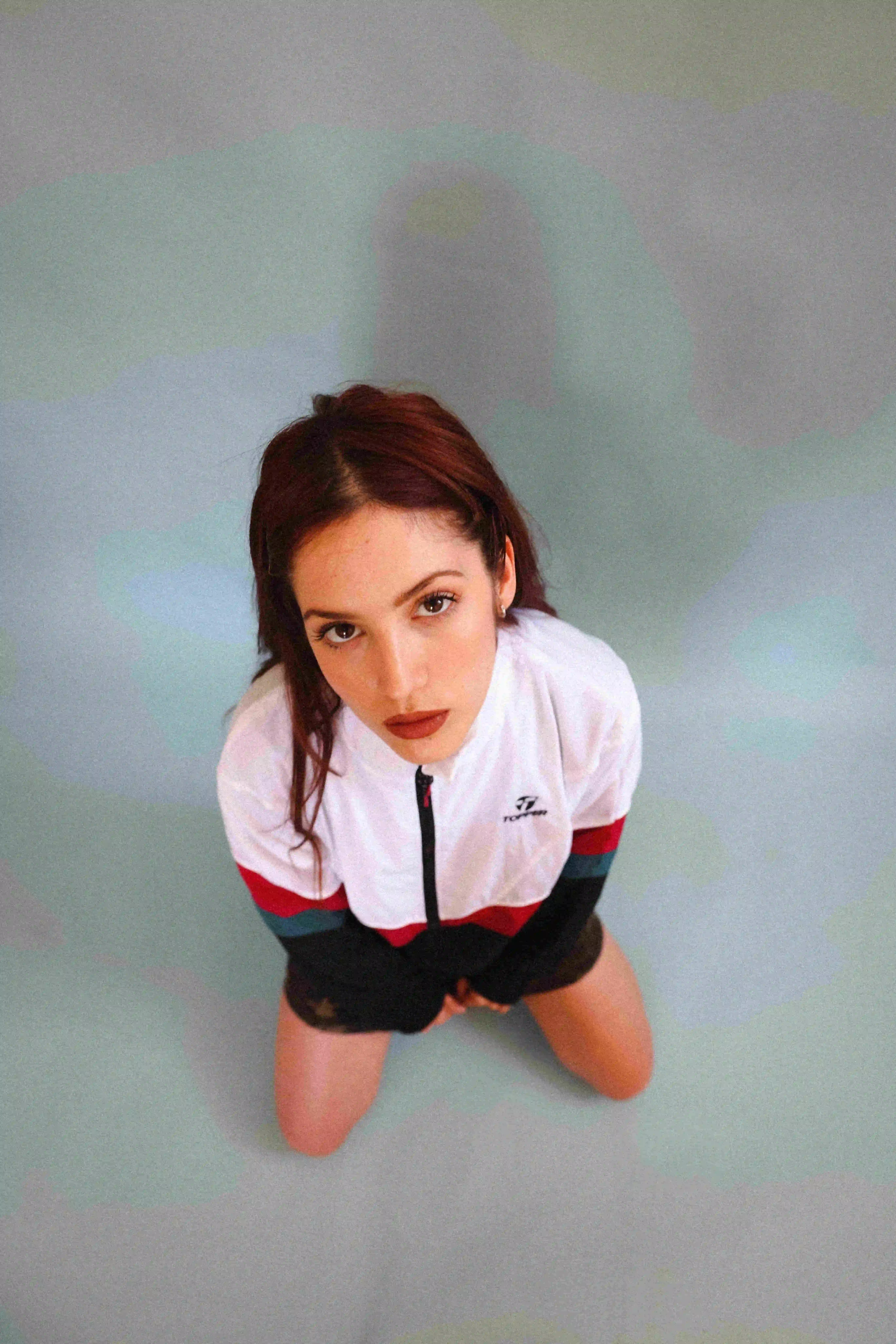 A woman in a white shirt and black shorts