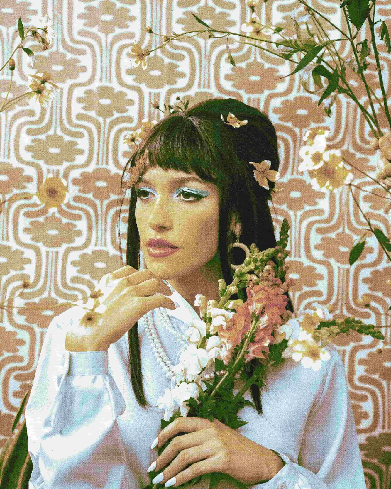 A woman in a white dress holding a bouquet of flowers