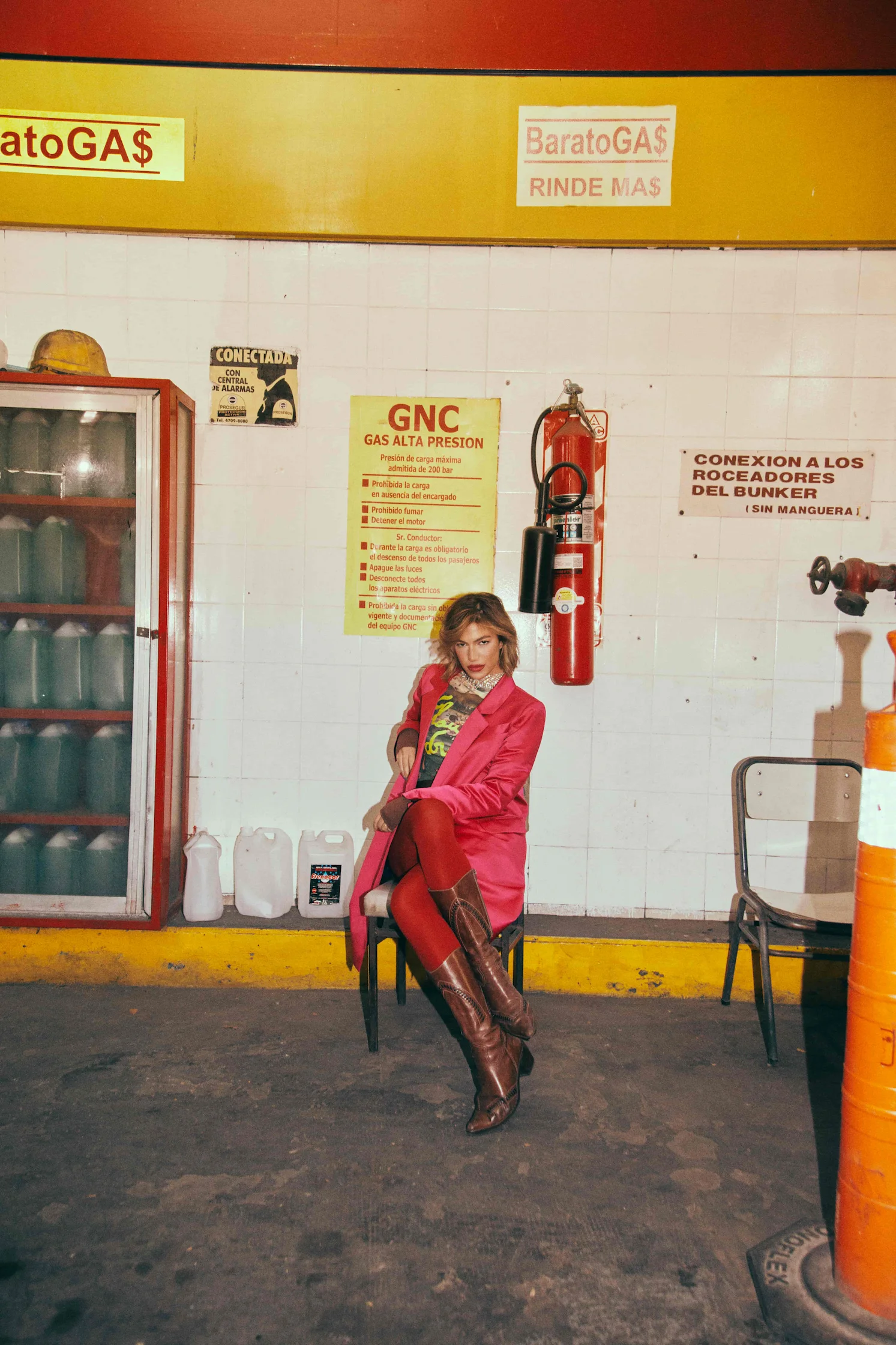 A woman sitting on a chair in front of a store