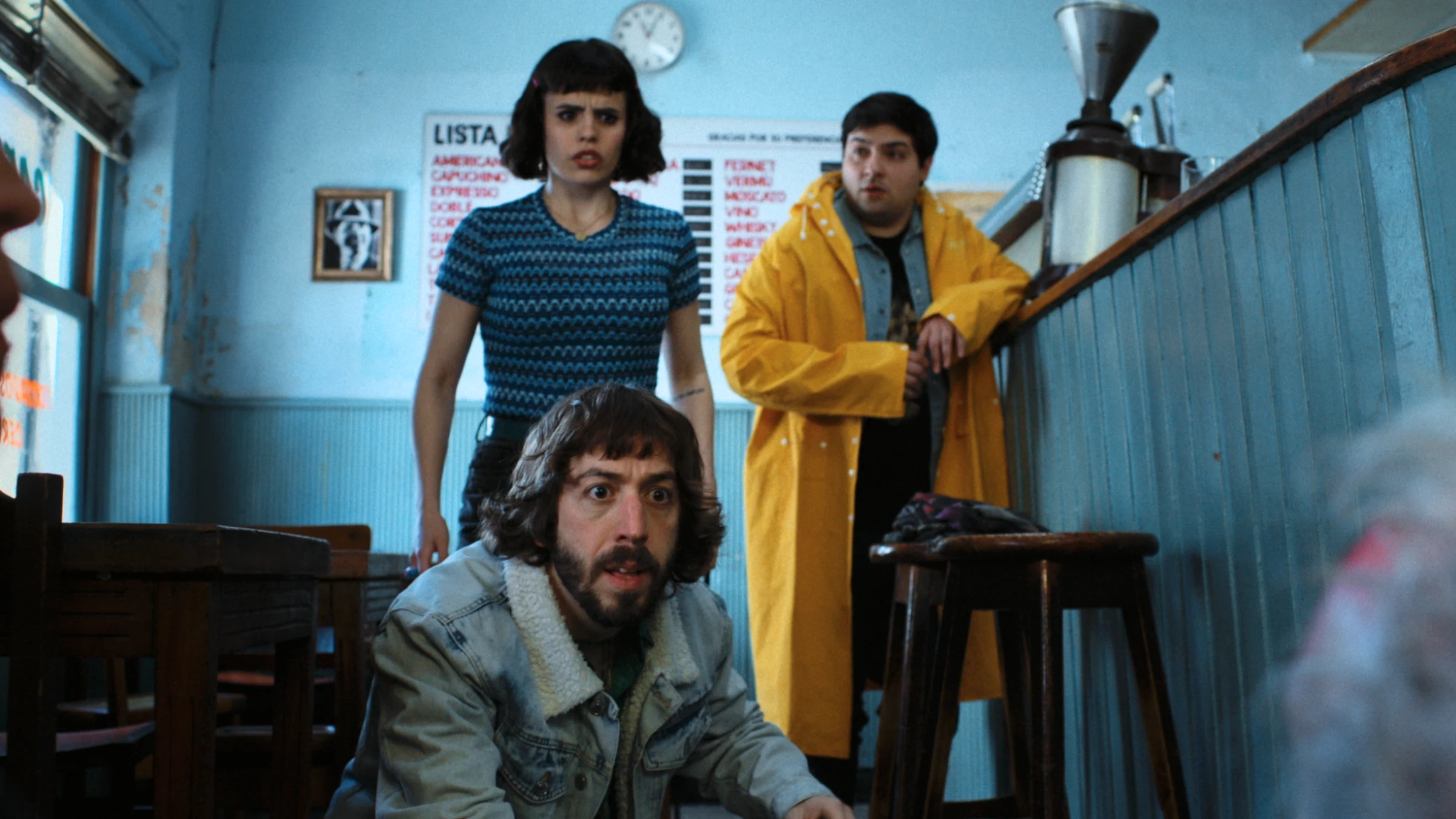 A group of people standing and sitting in a room