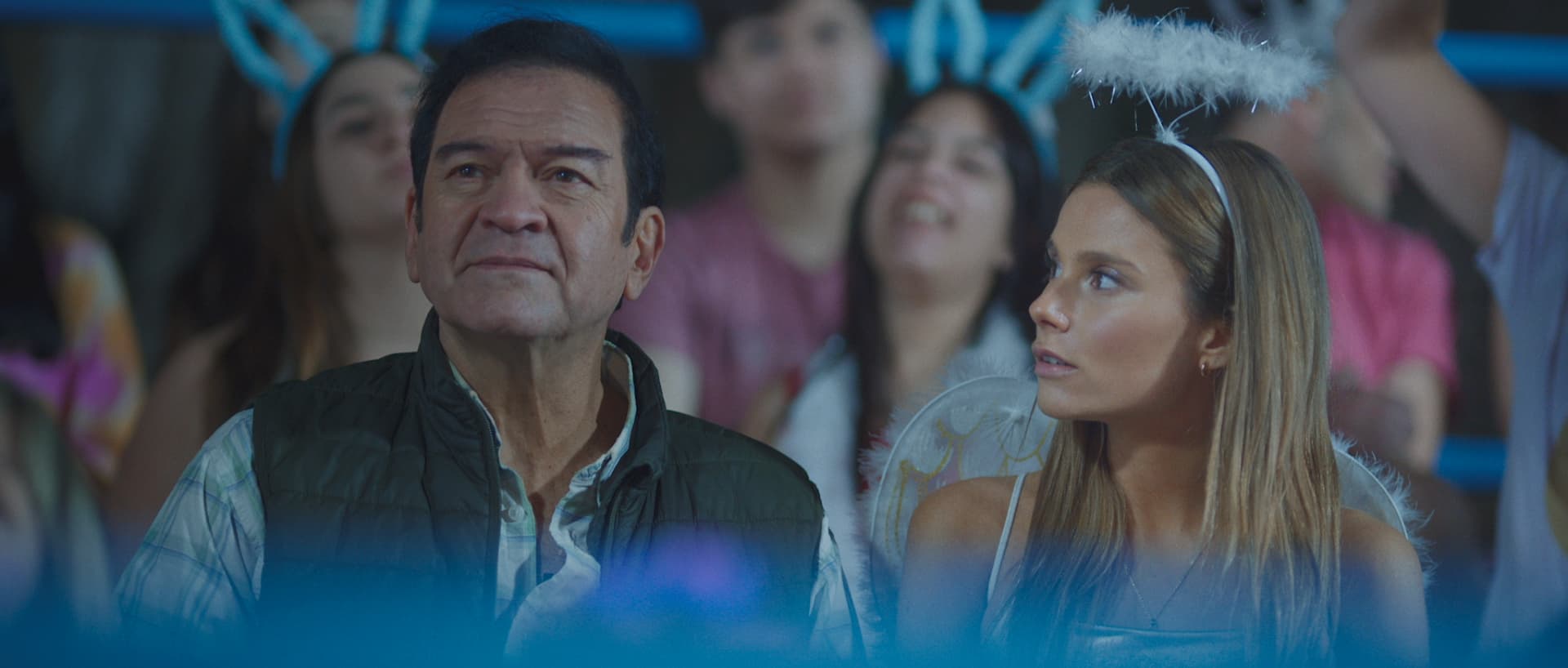 A man standing next to a woman in front of a crowd