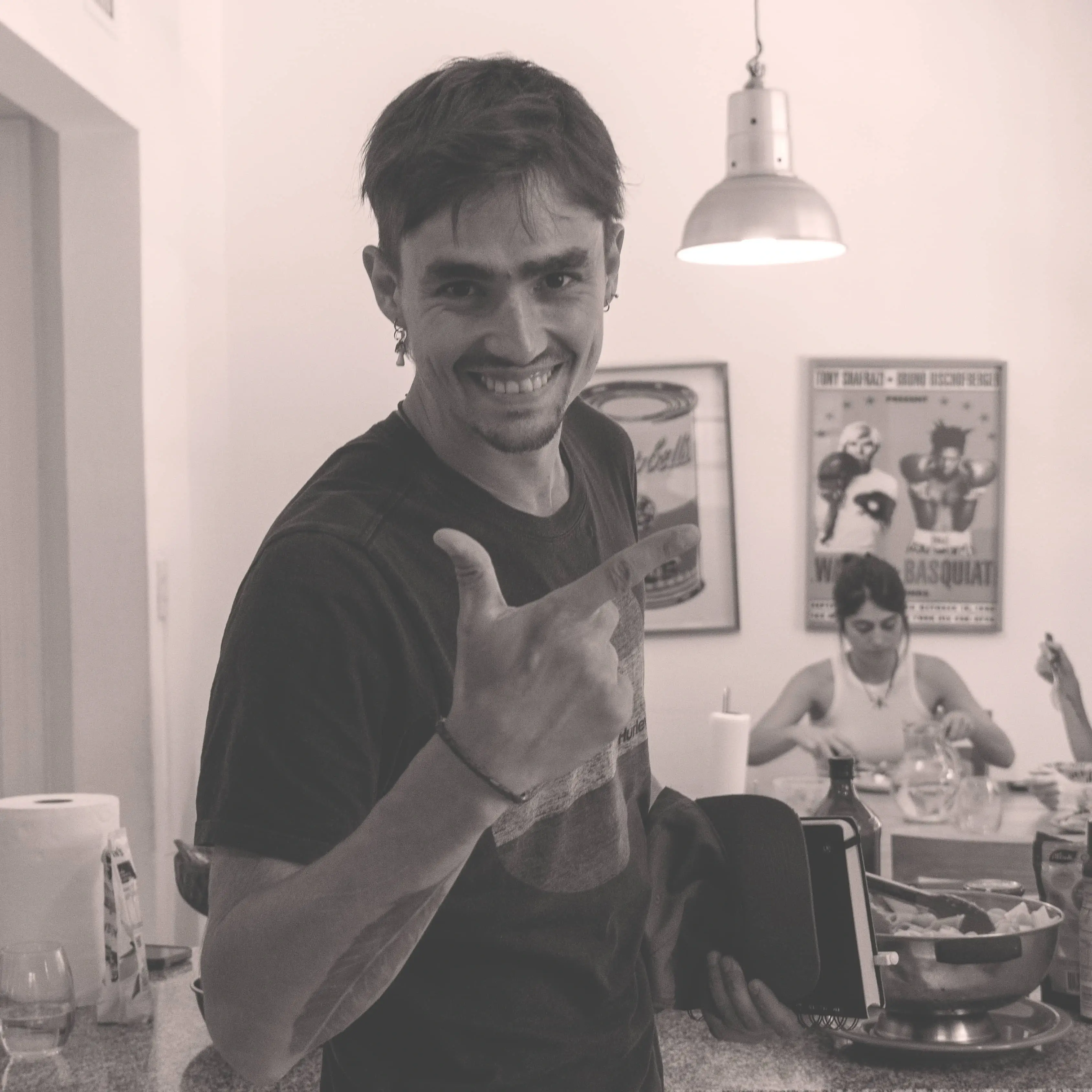 A man in a white shirt is smiling