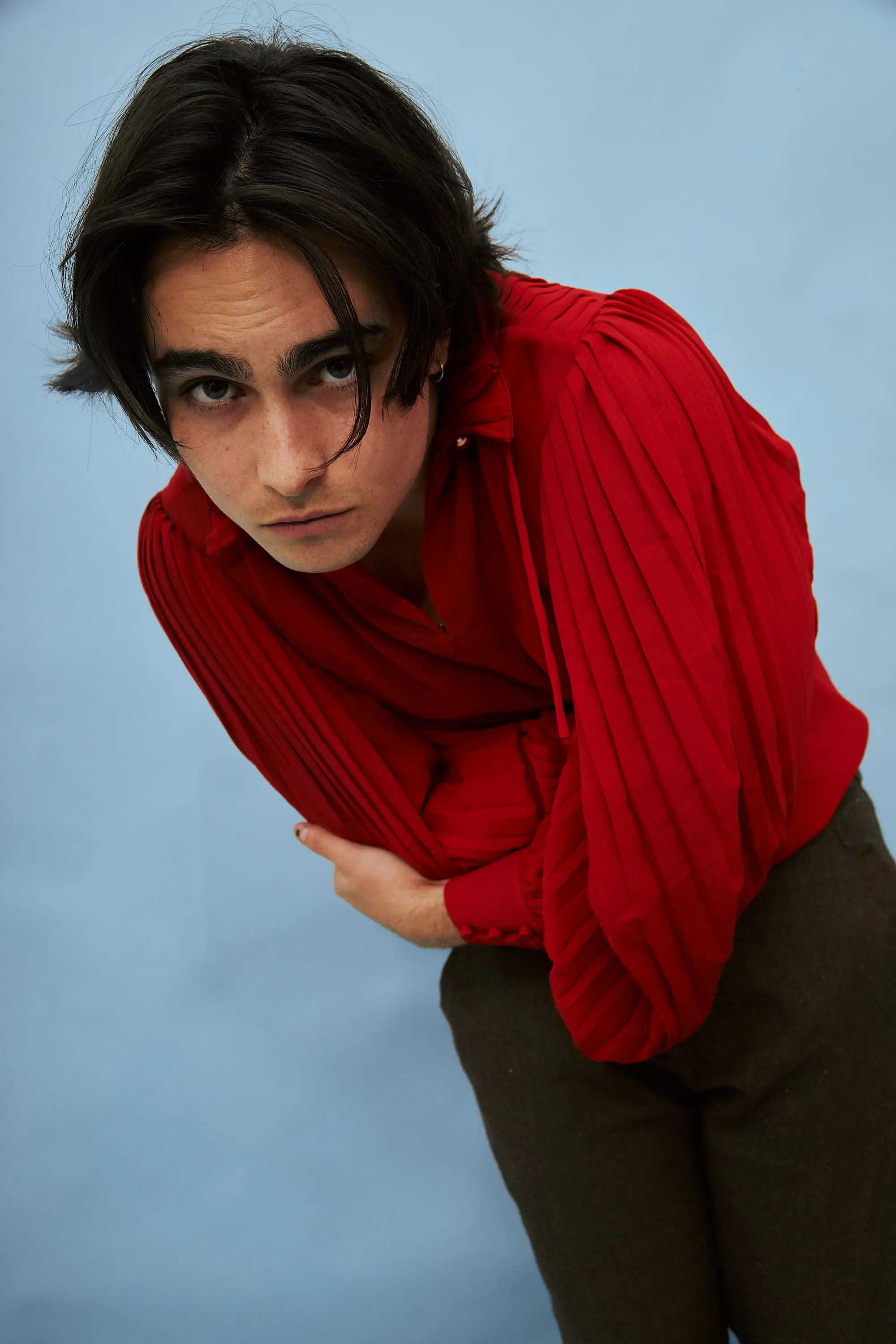 A man in a red shirt posing for a picture