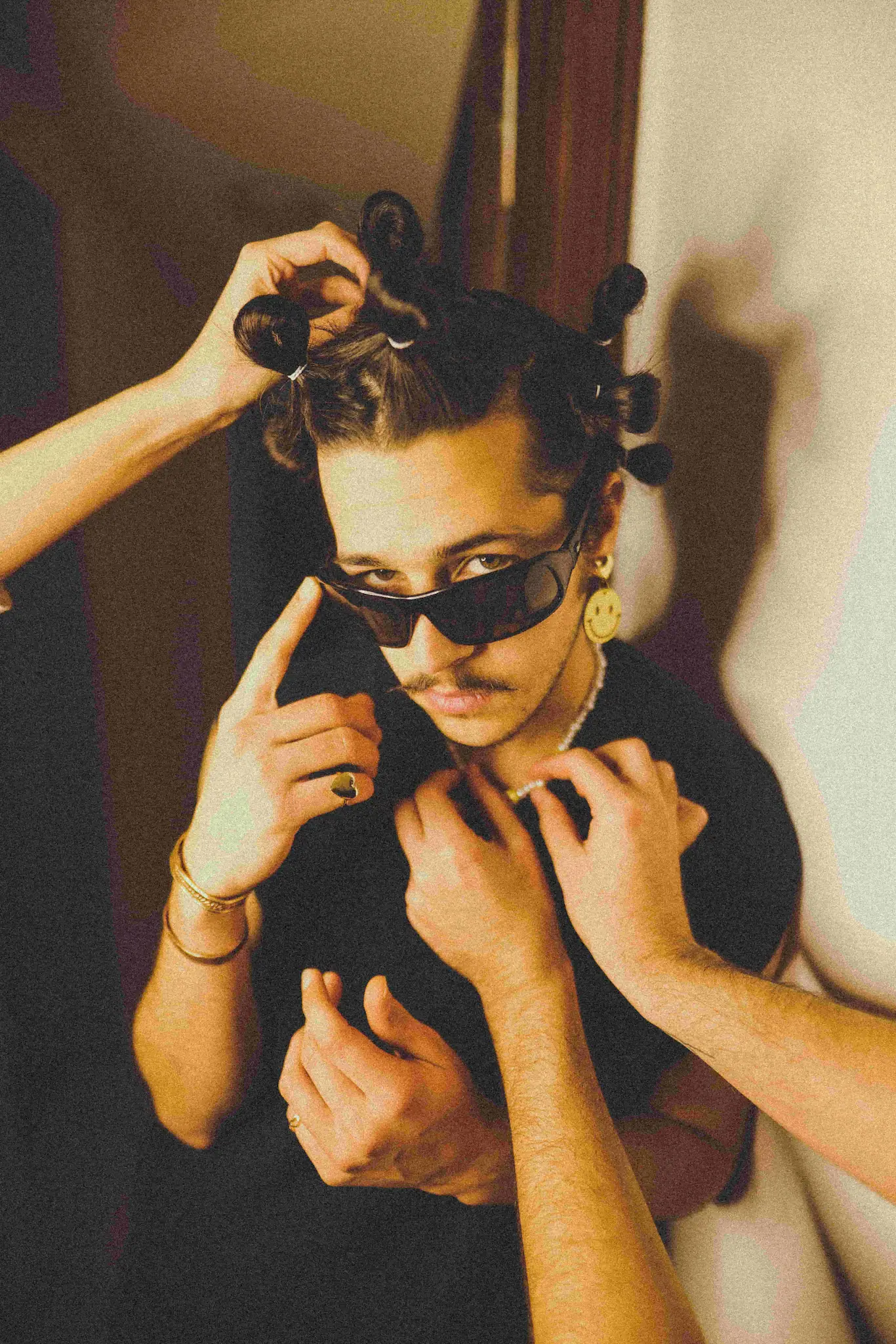 A man helping a woman put on her hair