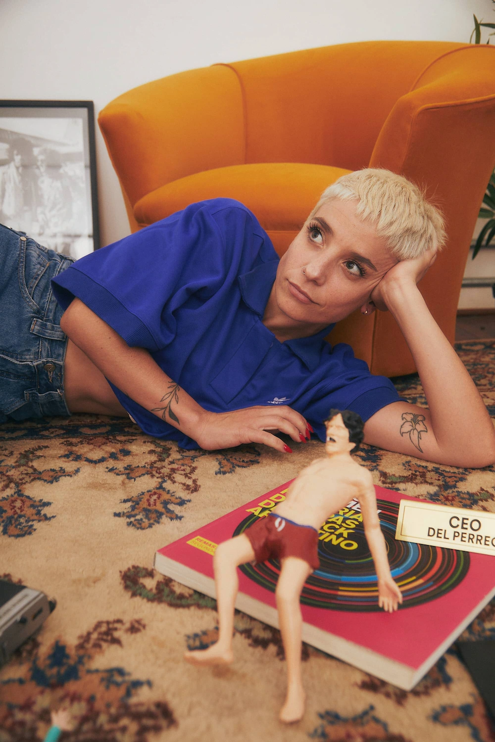 A woman laying on the floor next to a book