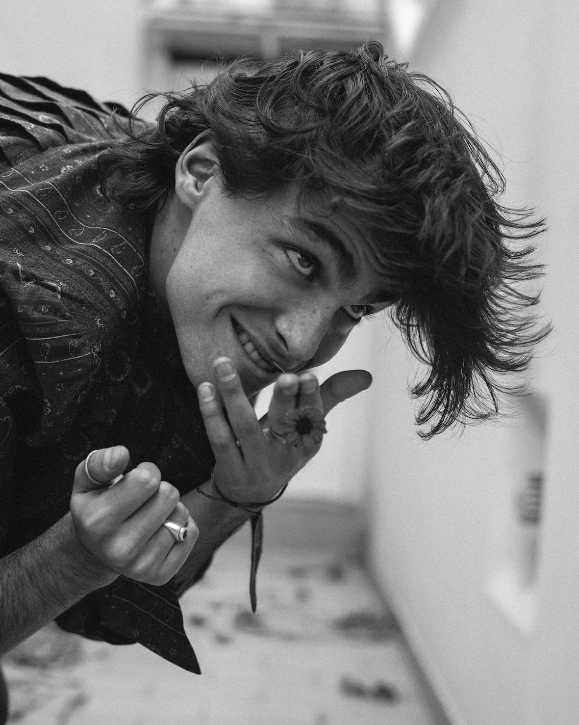A black and white photo of a man making a silly face