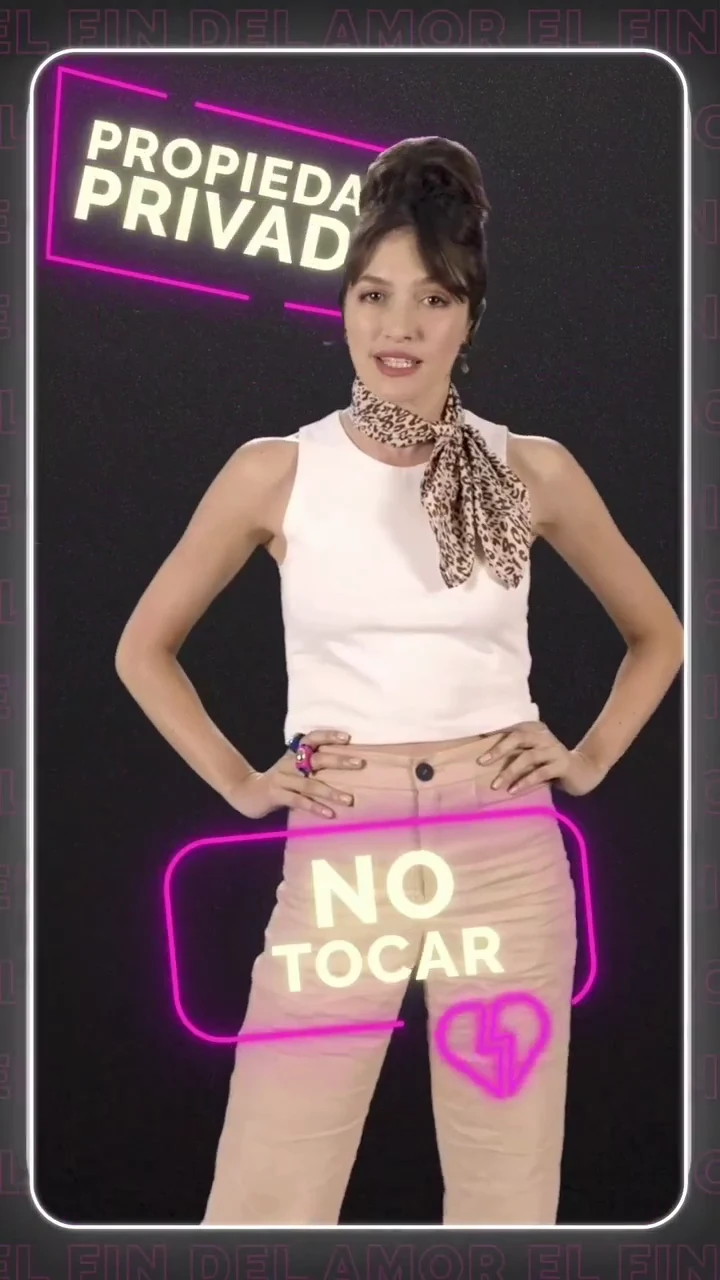 A woman standing in front of a neon sign