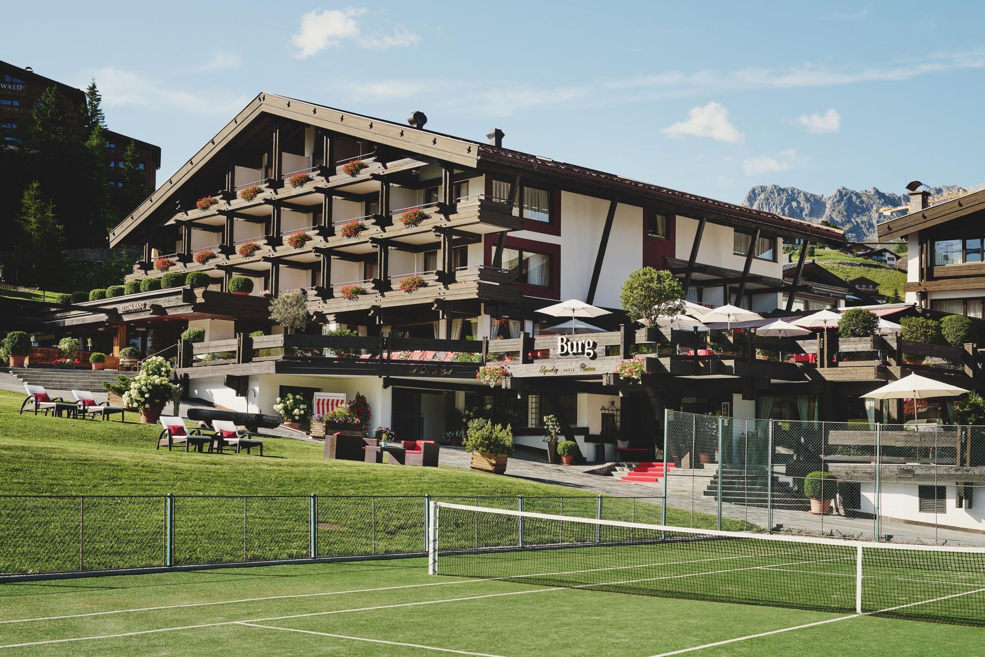 Burg Hotel in summer with tennis court