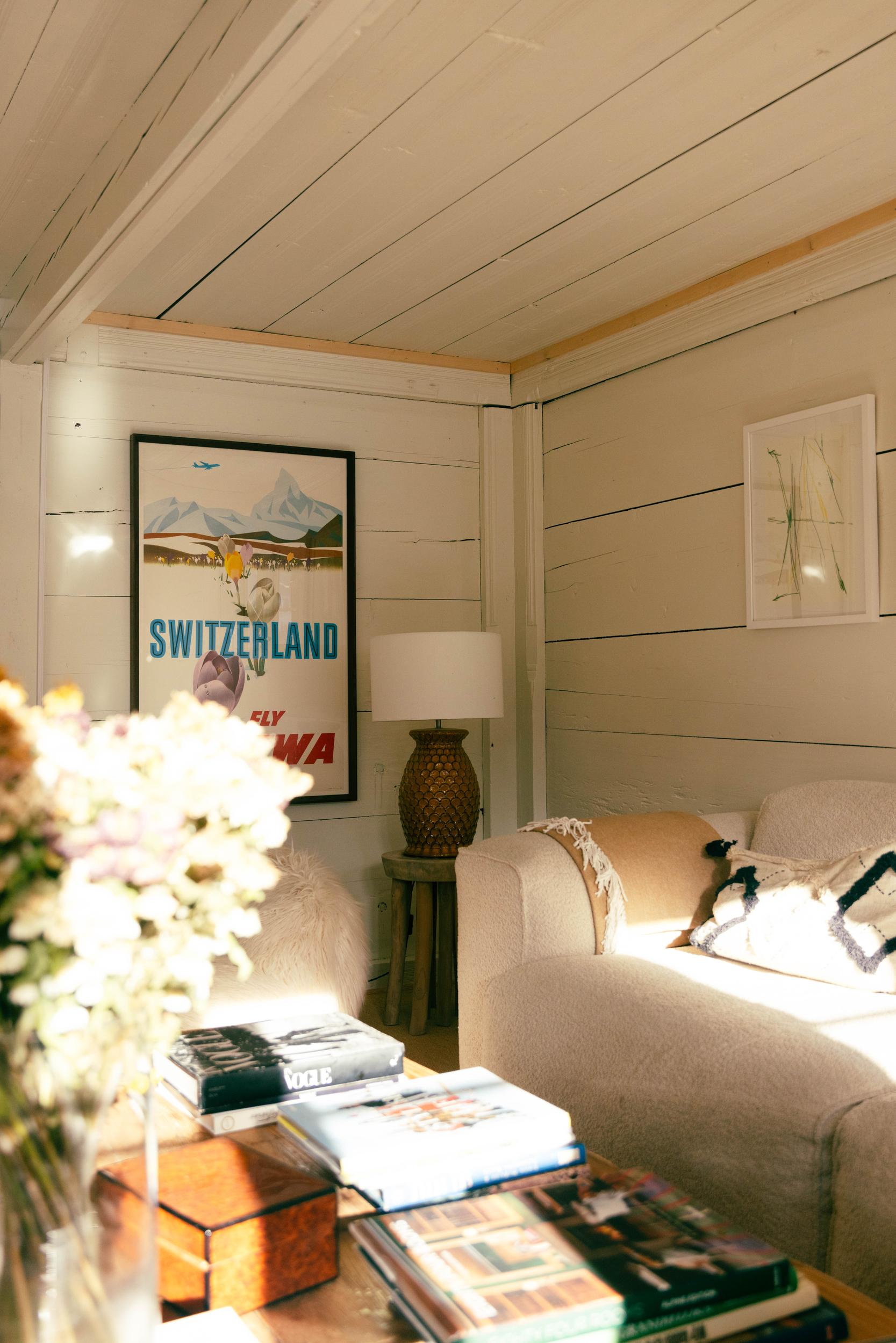 Le Chalet Lion Rouge_Nils Grubba_white salon details with flowers and poster