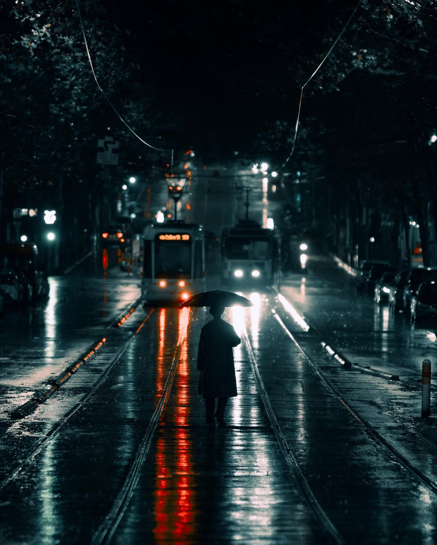 A man walking down a street holding an umbrella