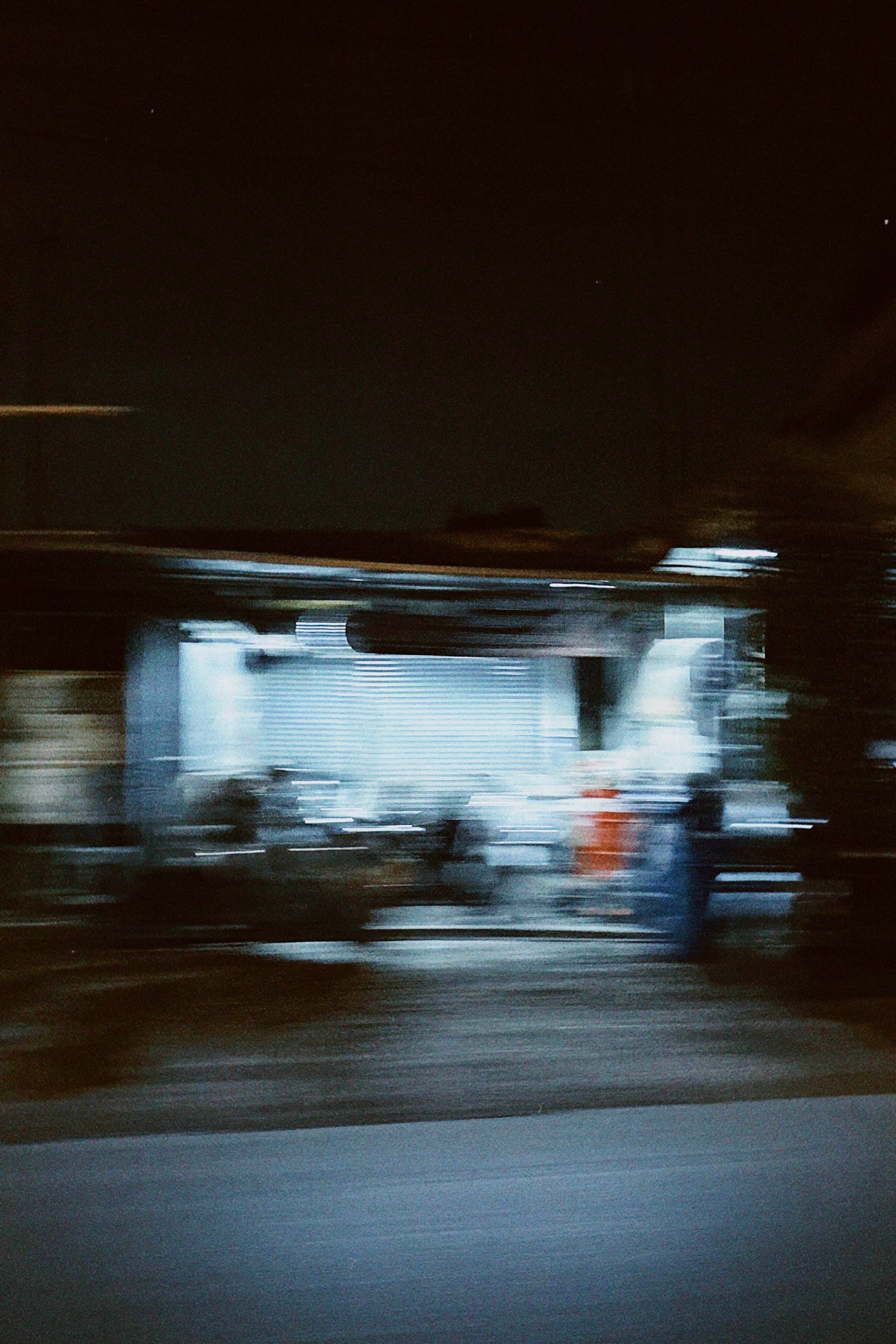 A blurry photo of a gas station at night