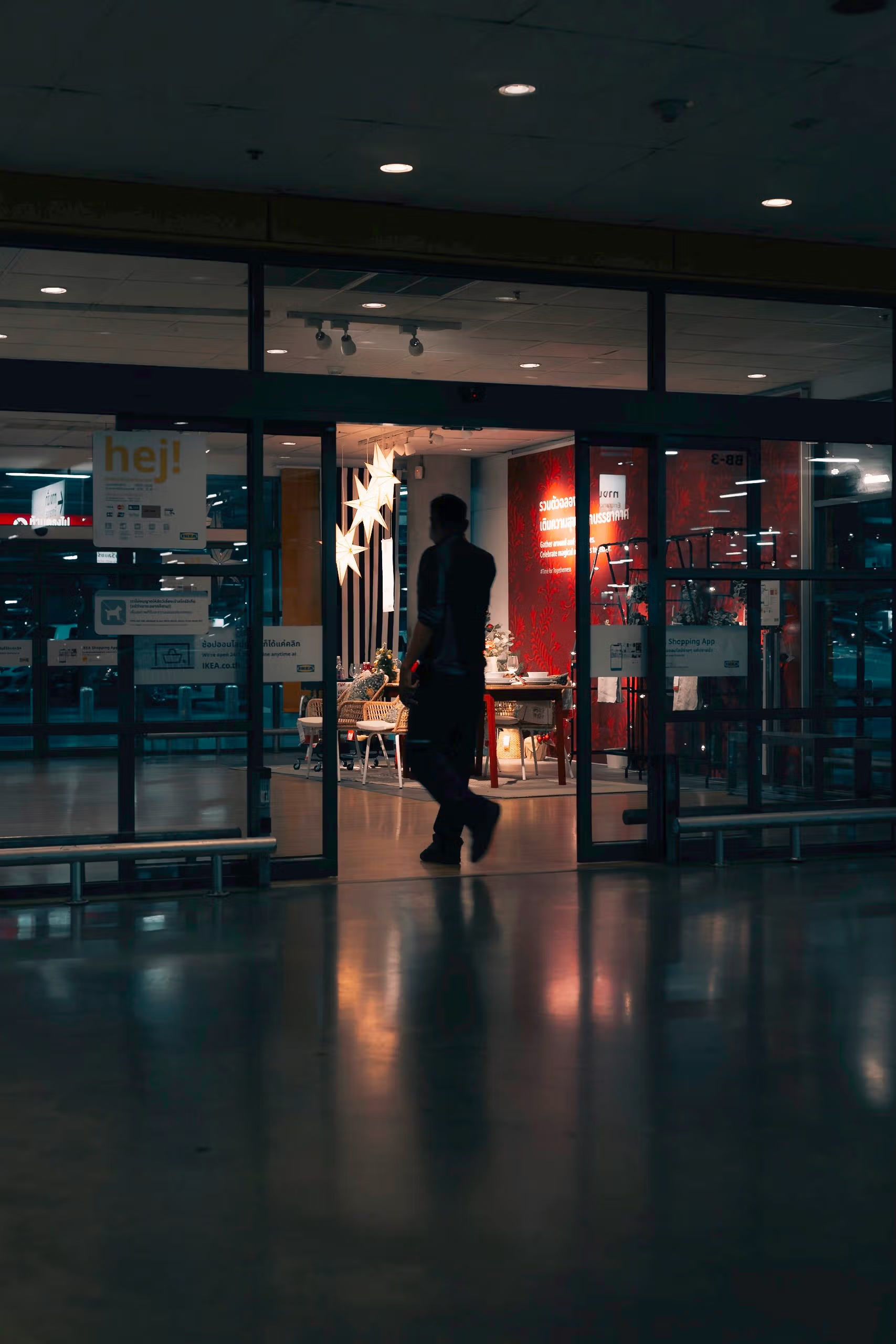 A person walking into a building at night