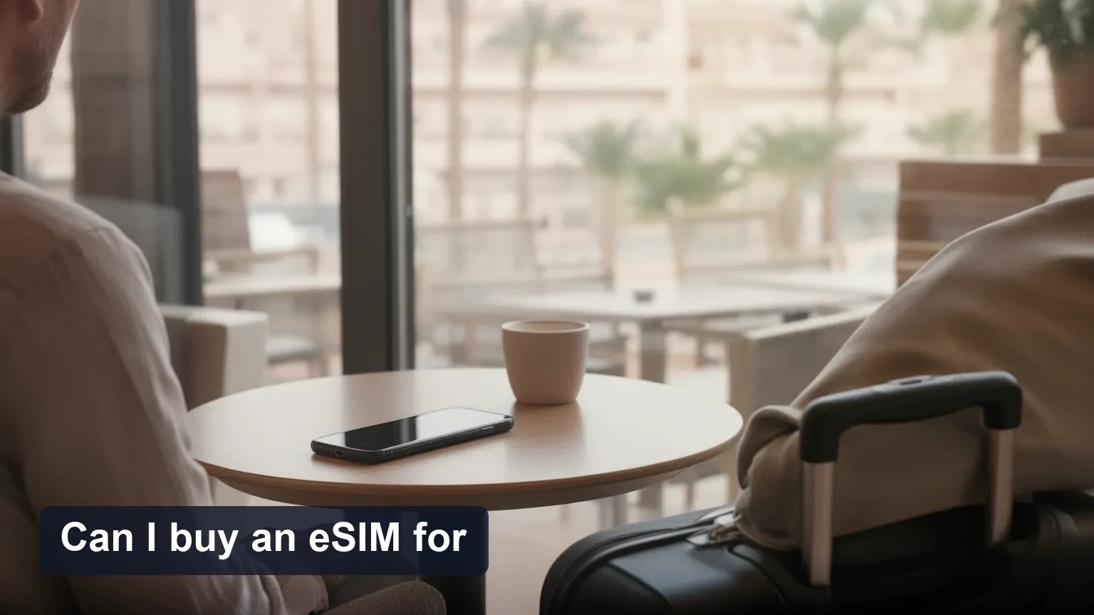 Traveler in an airport holding a phone with the screen turned away, preparing for eSIM activation