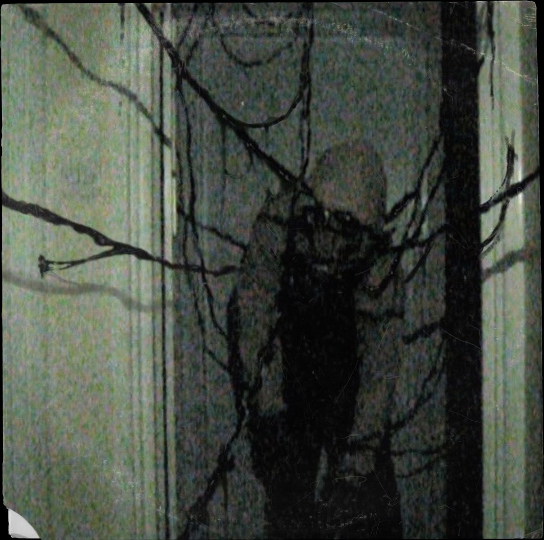 A black and white photo of a person standing in front of a door