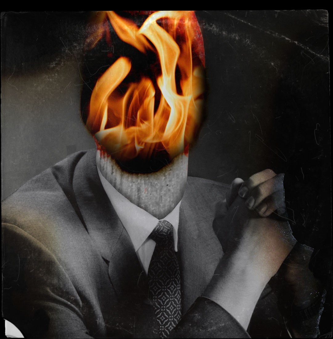 A man in a suit and tie with fire on his face