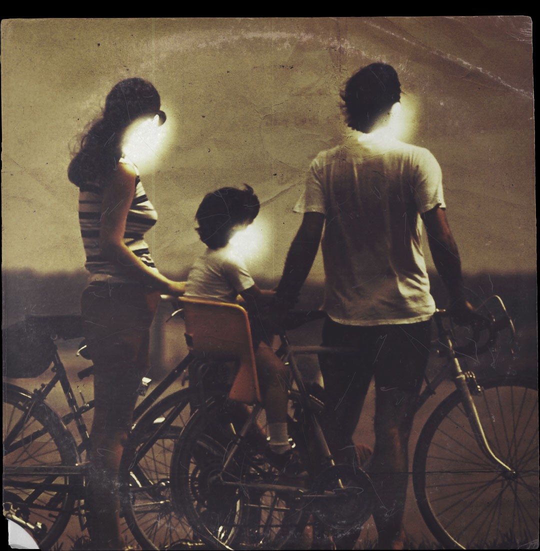 A group of people standing next to each other on a bike